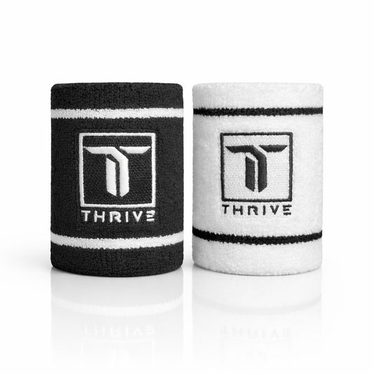Thrive Pickleball classic sweat-absorbing wristbands in black and white with embroidered logo, 4-inch athletic fit.